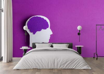 Head silhouette with a purple brain on purple background with copy space.  Wall mural