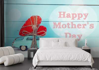 mothers day background with miniature blue toy car carrying a he Wall mural