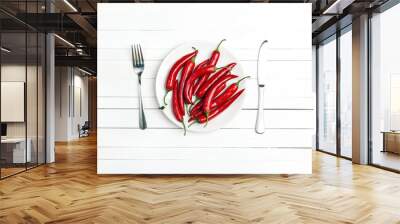 Red chilli pepper on a plate with cutlery on a white table. Wall mural