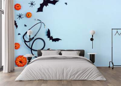 Stethoscope and Halloween decorations on blue background with copy space. Wall mural