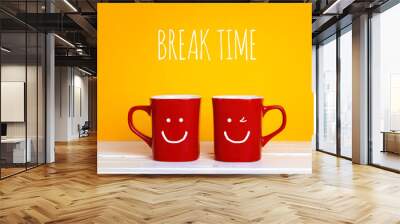 Two red coffee mugs with a smiling faces on a yellow background with the phrase Break time. Wall mural