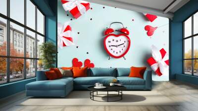 Valentine's day composition with alarm clock, gift boxes and hearts on a blue background. F Wall mural