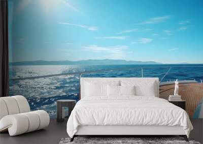 Yacht sailing in the open sea on a sunny day. View from the deck to the bow and sails. Wall mural