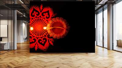 Top shot of two glowing terracotta lamps and rangoli against dark background. festival of light concept Wall mural