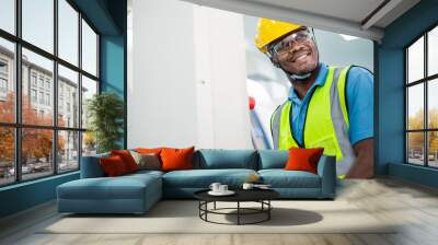 Black African American worker man control with industry machine at industrial factory. technology invention manufacturing. career and professional skill. diversity people working together. copy space Wall mural