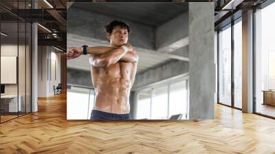 Caucasian topless young man warm up exercise before workout at gym. strong muscular men strengthening arm in fitness. healthy and lifestyle athletic people Wall mural