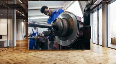 Diversity mechanic worker or metalworker using metal lathe machine operate polishing car disc brake at auto repair garage. Maintenance automotive and inspecting vehicle part concept Wall mural