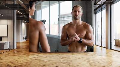 Portrait face of topless male intense looking at camera. Handsome athletic man sweating after workout in the fitness. Wall mural