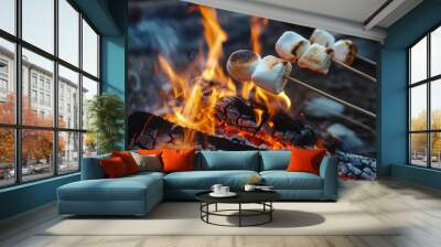 Toasting marshmallows on skewers over campfire Wall mural