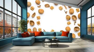 top view of walnuts closed and broken scattered on a white background with copy space Wall mural