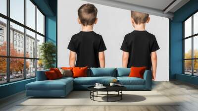 Boy wearing black t-shirt, back view, white isolate background. Wall mural