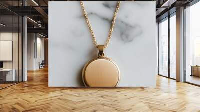 Elegant gold pendant necklace displayed on a marble surface, perfect for fashion and jewelry photography. Wall mural