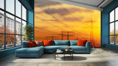 industrial landscape with power lines, high voltage towers and wind turbines on sunset sky background with defocused city lights, germany, saxony anhalt Wall mural