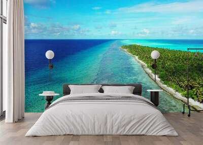 Aerial shot of a tropical island in the azure ocean Wall mural