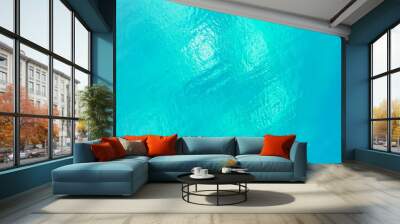 Aerial top shot of the crystal clear, blue water of the ocean Wall mural