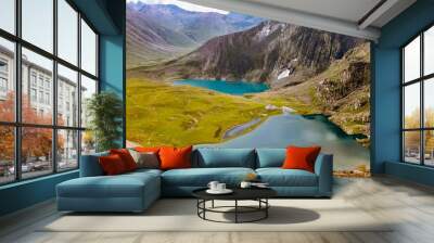 Beautiful mountain scenery. Turquoise lake, green valley, snow. Wall mural