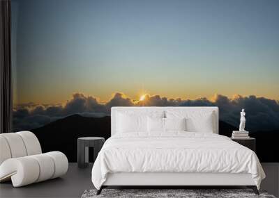 Beautiful shot of a large layer of clouds in a sunset sky visible from a mountain peak Wall mural