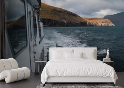 Boat on a peaceful journey through blue ocean, boat trip Faroe islands Wall mural