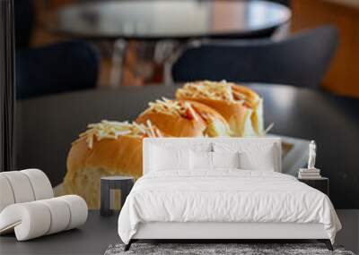 Close-up of two sandwiches on a wooden cutting board on a table Wall mural