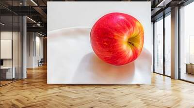 Close-up shot of a red apple on a white plate Wall mural