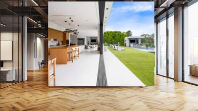 Contemporary interior with a wooden table and expansive glass wall connected to a pool area Wall mural