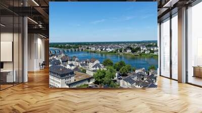 Aerial view of a city with residential buildings and a blue river in Tours, France, on a sunny day Wall mural