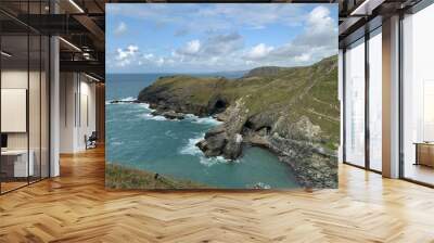 Beautiful view of Tintagel Castle with seascape under a blue cloudy sky Wall mural