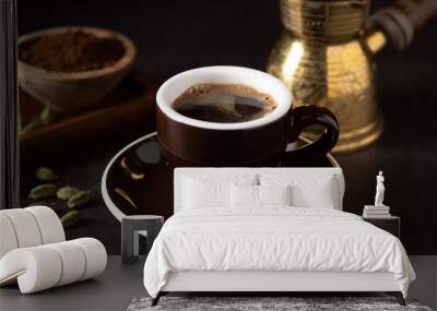 Cup of coffee with coffee beans on the table Wall mural