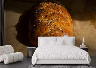 Freshly baked braided brioche sprinkled with nigella and sesame seeds Wall mural