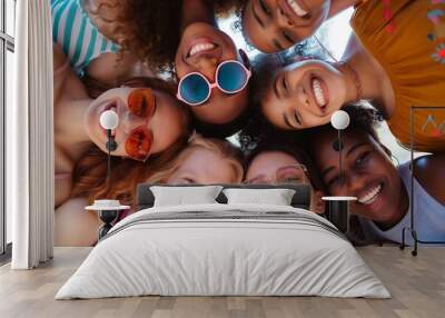 group of young people looking down at camera smiling together during summer time Wall mural