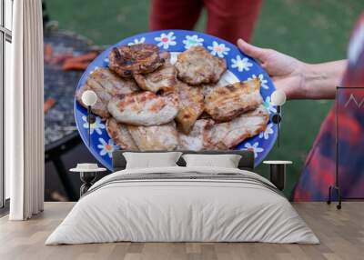 High angle shot of a barbeque plate with the grill in the background Wall mural