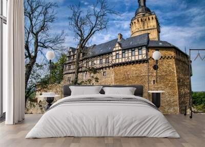 Historic castle with a tall tower and stone walls Wall mural