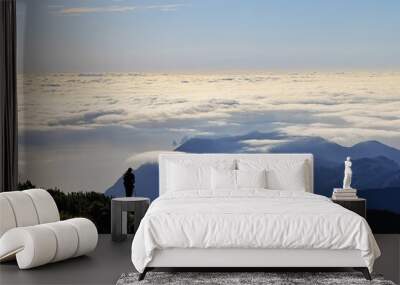 Photographer capturing mountain landscape above the clouds, Madeira Island Portugal Wall mural