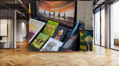 Street market with colorful paintings for sale lying on the floor Wall mural