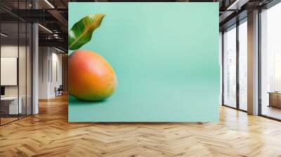 summer fresh ripe single mango with green leaf on solid green background copy space for text Wall mural