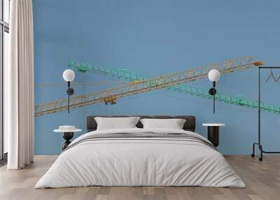 Two cranes, green and blue with sky background Wall mural