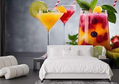 two different colored drinks are sitting on a table with fruit Wall mural