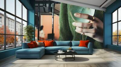 Vertical closeup of female hand holding a glass of fresh hugo Wall mural