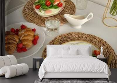 Vertical shot of croissants salmons and caprese salad on plates in the kitchen Wall mural