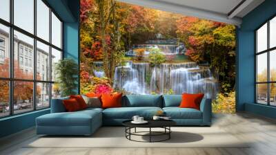 Beautiful and colorful waterfall in deep forest during idyllic autumn Wall mural