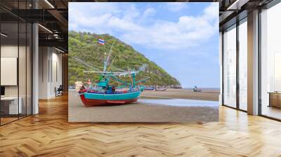 Fishing boat on beach near fisherman village at Khao Kalok mountain, near Hua Hin, Thailand Wall mural