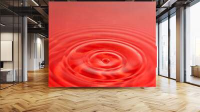 Water droplets make the red water surface spread the background image. Wall mural