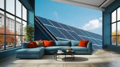 A modern house featuring solar panels on a roof under a clear blue sky, emphasizing renewable energy and sustainability. Wall mural