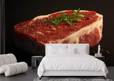 Fresh raw steak with seasoning on a dark background, perfect for culinary presentations. Wall mural