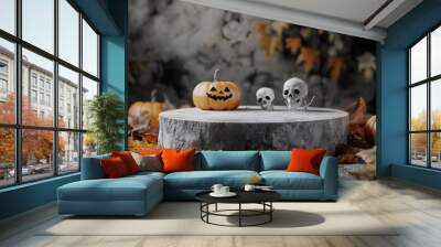 A jack-o'-lantern and two skulls sit on a stone platform surrounded by fall leaves. Wall mural