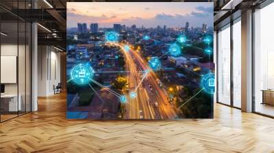 Aerial view of a city at night with glowing digital icons above buildings and streets connecting them. Wall mural