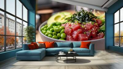 Close-up of a poke bowl with tuna, avocado, edamame, seaweed, and sesame seeds. Wall mural