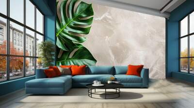 Two large green tropical leaves on a beige textured background with copy space. Wall mural