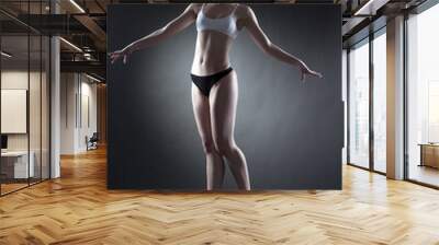 studio shot of graceful dancer posing in jump Wall mural