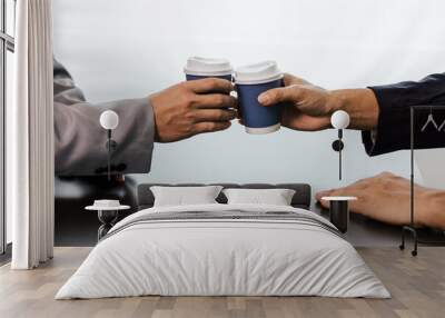 Close-up shot of male businessman hitting white cup of coffee in coffee shop while discussing work Wall mural